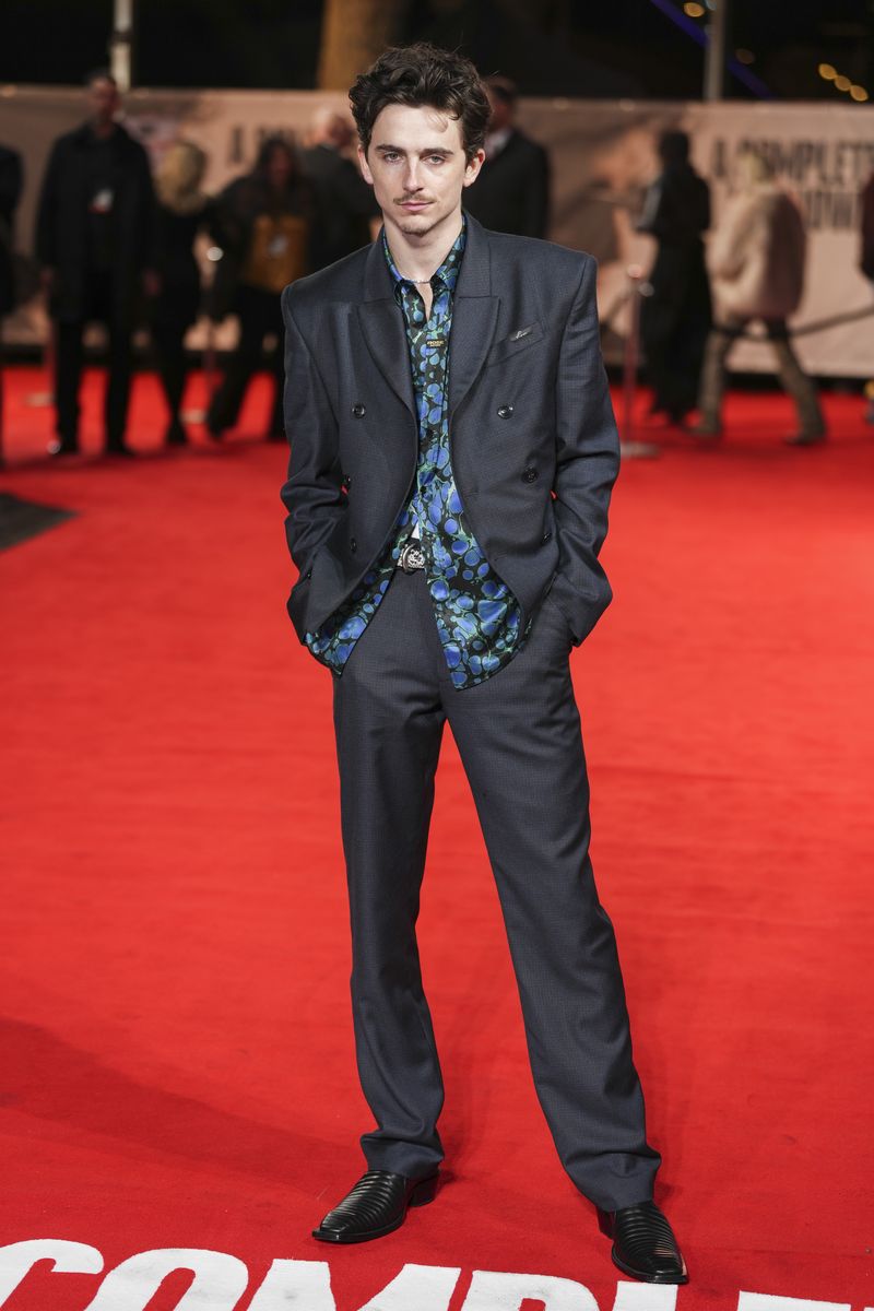 Timothee Chalamet rides an electronic bicycle upon arrival at the premiere of the film 'A Complete Unknown' in London, on Tuesday, Jan. 14, 2025. (Photo by Scott A Garfitt/Invision/AP)