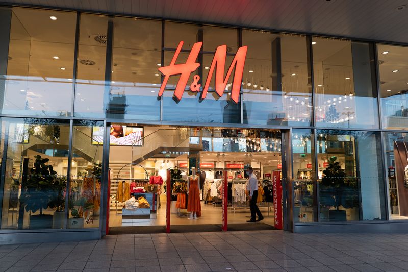 Warsaw, Poland - June 18, 2020: Entrance to H&M store, clothing retail company in the city center at night