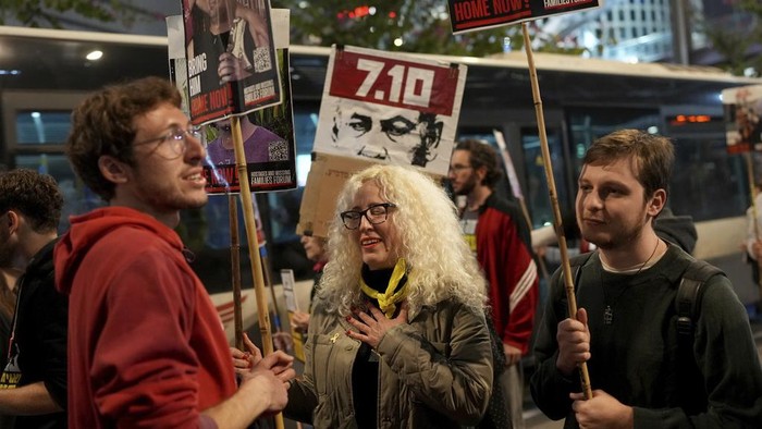 Relatives and friends of people killed and abducted by Hamas and taken into Gaza, react to the ceasefire announcement as they take part in a demonstration in Tel Aviv, Israel, Wednesday, Jan. 15, 2025. (AP Photo/Ohad Zwigenberg)