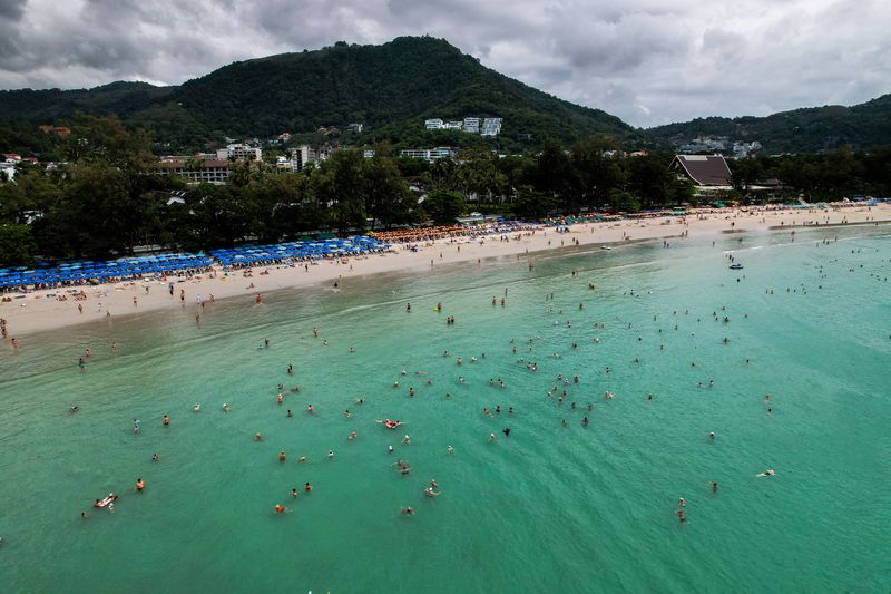 Tourists gather at Patong beach in Phuket, Thailand, November 22, 2024. REUTERS/Napat Wesshasartar