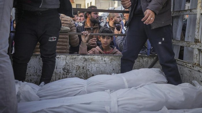 Palestinians celebrate the announcement of a ceasefire deal between Hamas and Israel in Deir al-Balah, central Gaza Strip, Wednesday, Jan. 15, 2025. (AP Photo/Abdel Kareem Hana)