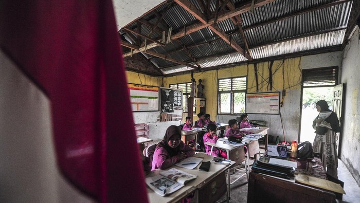 Guru memeberi materi pelajaran kepada siswa kelas IV di ruang perpustakaan yang dijadikan kelas di SDN 109 Desa Ladang Panjang, Muaro Jambi, Jambi, Jumat (17/1/2025). SD tertua di Desa Ladang Panjang, dibangun tahun 1983 itu memiliki keterbatasan ruang kelas sehingga terpaksa memanfaatkan ruang perpustakaan yang rusak untuk kegiatan belajar mengajar selama hampir 20 tahun. ANTARA FOTO/Wahdi Septiawan/Spt.