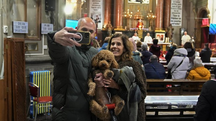 Saat Hewan Peliharaan Antre untuk Diberkati Pada Hari Santo Antonius di Spanyol A dog is anointed by father Valentine during the feast of Saint Anthony, Spain's patron saint of animals at the San Anton church in Madrid, Spain, Friday, Jan. 17, 2025. (AP Photo/Paul White)