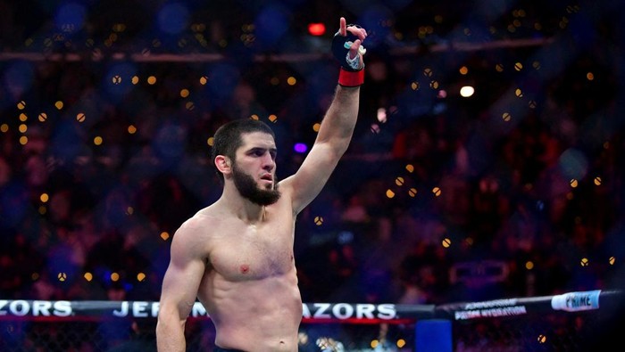 Jan 18, 2025; Inglewood, California, USA; Islam Makhachev (red gloves) reacts after defeating Renato Moicano (blue gloves) in a lightweight title fight during UFC 311 at Intuit Dome. Mandatory Credit: Gary A. Vasquez-Imagn Images     TPX IMAGES OF THE DAY