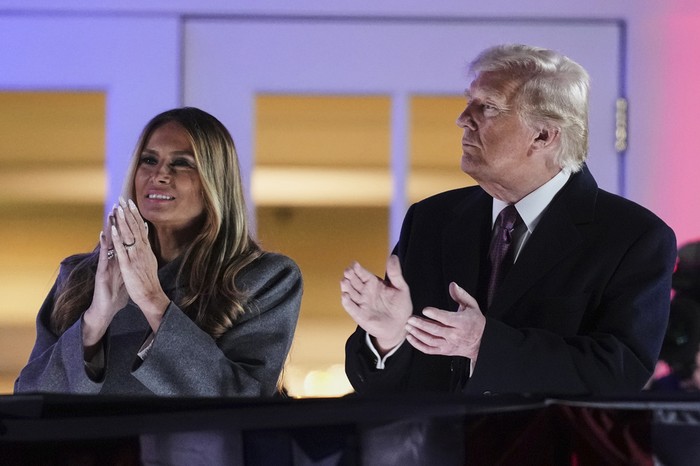 President-elect Donald Trump, right, and Melania Trump watch fireworks at Trump National Golf Club in Sterling, Va., Saturday, Jan. 18, 2025, ahead of the 60th Presidential Inauguration. (AP Photo/Matt Rourke)