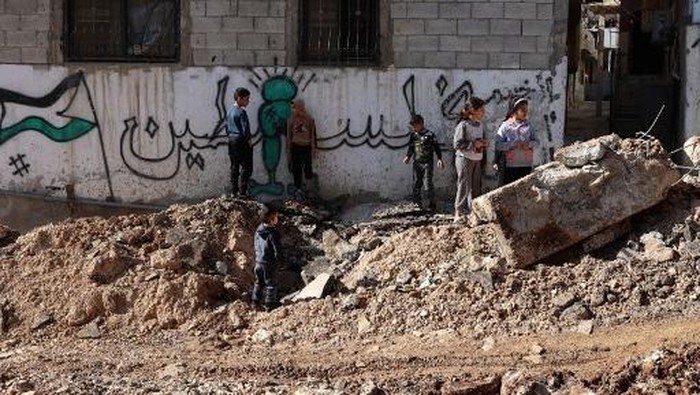 Palestinians inspect a road, which was unearthed during a raid by Israeli forces, in the Fara camp for Palestinian refugees near Tubas in the north of the occupied West Bank on January 7, 2025. (Photo by Zain JAAFAR / AFP)