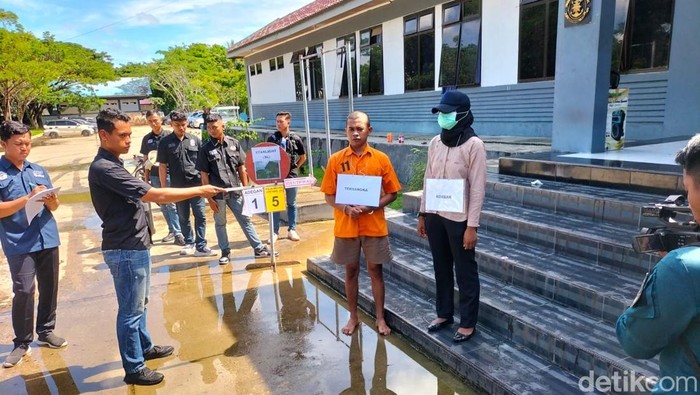 Tampang oknum TNI AL (baju oranye), pelaku pembunuh wanita di Sorong saat mengikuti rekonstruksi.