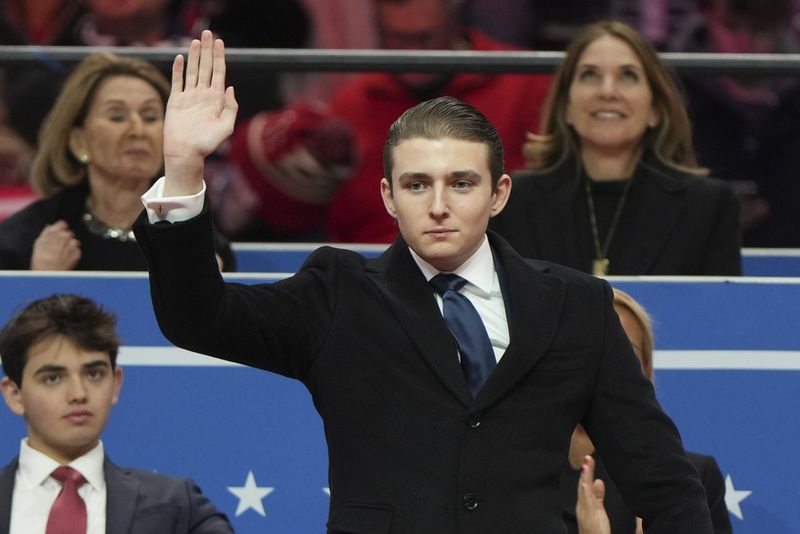 Barron Trump, left, and his grandfather Viktor Knavs stand before the 60th Presidential Inauguration in the Rotunda of the U.S. Capitol in Washington, Monday, Jan. 20, 2025. (Kenny Holston/The New York Times via AP, Pool)