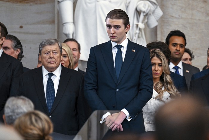 Barron Trump, left, and his grandfather Viktor Knavs stand before the 60th Presidential Inauguration in the Rotunda of the U.S. Capitol in Washington, Monday, Jan. 20, 2025. (Kenny Holston/The New York Times via AP, Pool)