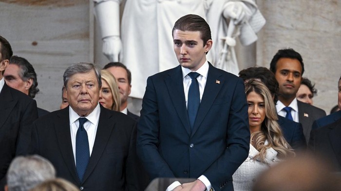 Barron Trump, left, and his grandfather Viktor Knavs stand before the 60th Presidential Inauguration in the Rotunda of the U.S. Capitol in Washington, Monday, Jan. 20, 2025. (Kenny Holston/The New York Times via AP, Pool)