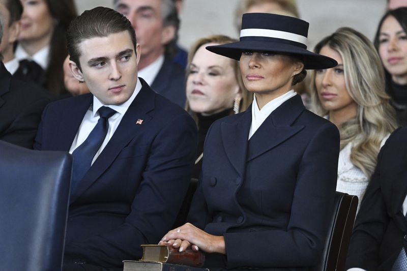 Barron Trump and first lady Melania Trump listen as President Donald Trump delivers remarks after being sworn in during the 60th Presidential Inauguration in the Rotunda of the U.S. Capitol in Washington, Monday, Jan. 20, 2025. (Saul Loeb/Pool photo via AP)