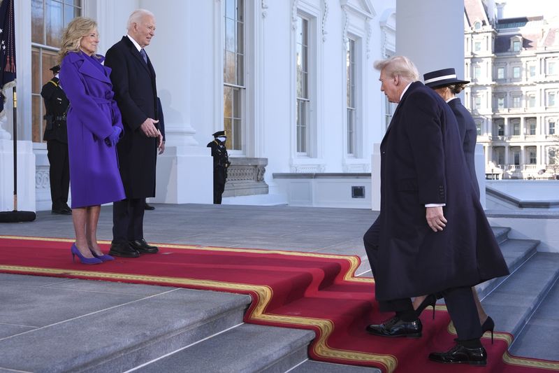 President Joe Biden, center left, and first lady Jill Biden, left, greet President-elect Donald Trump, center right, and Melania Trump, right, upon arriving at the White House, Monday, Jan. 20, 2025, in Washington. (AP Photo/Evan Vucci)
