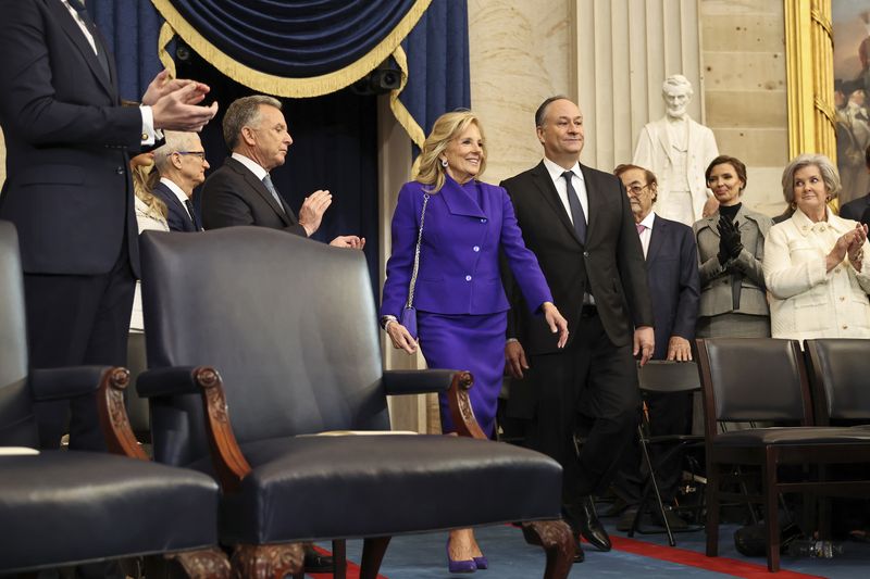 First lady Jill Biden and second gentleman Doug Emhoff arrive to the 60th Presidential Inauguration in the Rotunda of the U.S. Capitol in Washington, Monday, Jan. 20, 2025. (Chip Somodevilla/Pool Photo via AP)