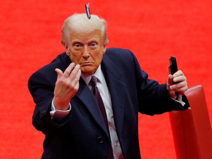 U.S. President Donald Trump throws a pen after he signed executive orders next to U.S. Vice President JD Vance on the inauguration day of Trumps second Presidential term, inside Capital One Arena, in Washington, U.S. January 20, 2025. REUTERS/Brian Snyder