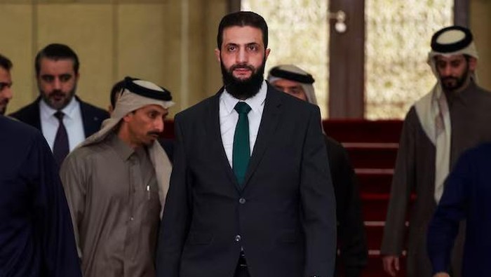 Syrias de facto leader Ahmed al-Sharaa, also known as Abu Mohammed al-Golani, walks on the day he meets with Qatars Minister of State Mohammed bin Abdulaziz Al-Khulaifi, after the ousting of Syrias Bashar al-Assad, in Damascus, Syria, December 23, 2024. REUTERS/Ammar Awad/File Photo Purchase Licensing Rights