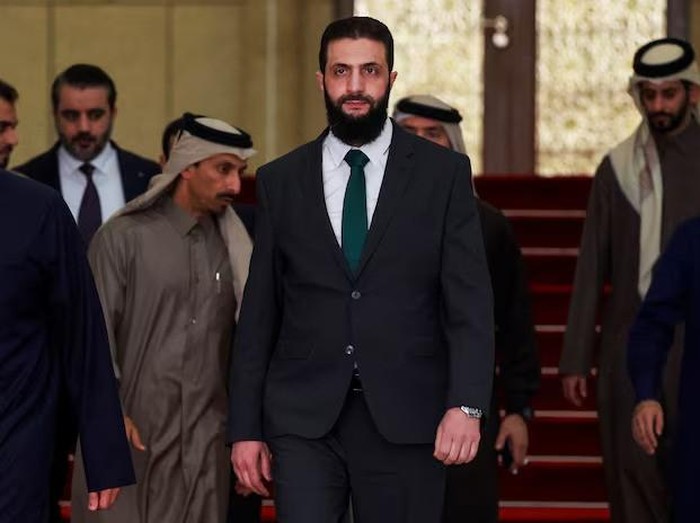 Syrias de facto leader Ahmed al-Sharaa, also known as Abu Mohammed al-Golani, walks on the day he meets with Qatars Minister of State Mohammed bin Abdulaziz Al-Khulaifi, after the ousting of Syrias Bashar al-Assad, in Damascus, Syria, December 23, 2024. REUTERS/Ammar Awad/File Photo Purchase Licensing Rights