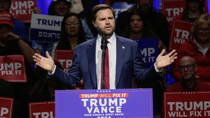 FILE PHOTO: Republican vice presidential nominee JD Vance speaks to supporters during a campaign stop at the Capitol Theatre in Flint, Michigan, U.S. November 4, 2024.  REUTERS/Rebecca Cook/File Photo