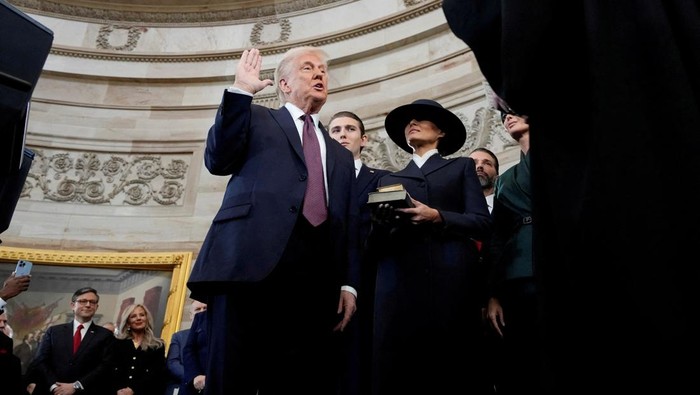 Donald Trump is sworn in as the 47th president of the United States by Chief Justice John Roberts as Melania Trump holds the Bible during the 60th Presidential Inauguration in the Rotunda of the U.S. Capitol in Washington, Monday, Jan. 20, 2025. Morry Gash/Pool via REUTERS