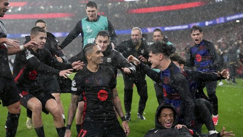 Barcelonas Raphinha celebrates his sides fifth goal during a Champions League opening phase soccer match between SL Benfica and FC Barcelona at the Luz stadium in Lisbon, Tuesday, Jan. 21, 2025. (AP Photo/Armando Franca)