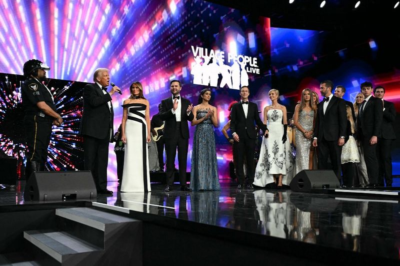 US President Donald Trump (2nd L) stands with First Lady Melania Trump, US Vice President J.D. Vance, Second Lady Usha Vance, Jared Kushner, daughter Ivanka Trump, granddaughter Kai Madison Trump, sons Donald Trump Jr. and Eric Trump, and daughter Tiffany during the Liberty inaugural ball in Washington, DC, on January 20, 2025. (Photo by Jim WATSON / AFP)