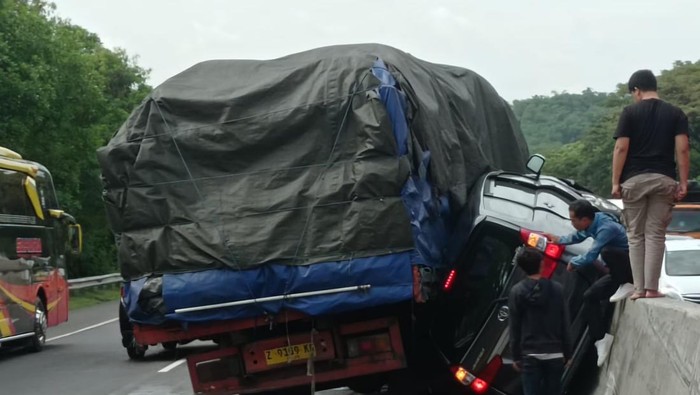 Kecelakaan di Km 80 Tol Cipularang mengakibatkan mobil Avanza terjepit di antara truk dengan pembatas jalan.