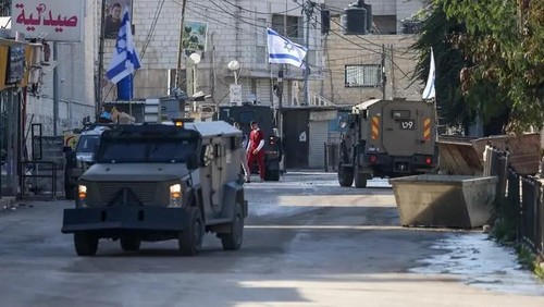 Israeli forces in armoured vehicles conduct a raid in Jenin in the occupied West Bank on January 21, 2025. (Reuters)