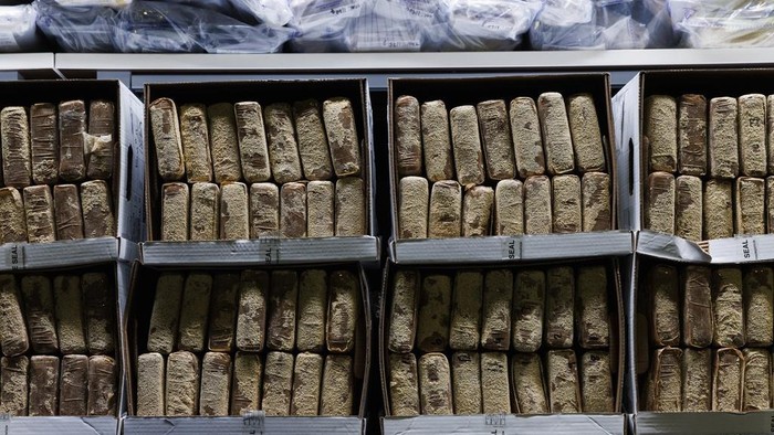 Toronto Police Chief Myron Demkiw, center, speaks to media behind a wall of seized drugs during a press conference announcing the seizure of 835 kg., about 1,840 lbs. of cocaine, Tuesday, Jan. 21, 2025, in Toronto. (Cole Burston/The Canadian Press via AP)