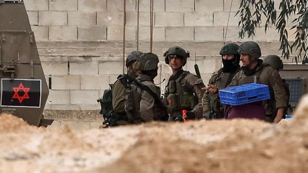 Tamer Abu Zaho, who tried to deliver bread, medicines and diapers to his mother, who is trapped inside a Jenin hospital amid an Israeli raid, stands, in the Israeli-occupied West Bank, January 22, 2025. REUTERS/Ammar Awad