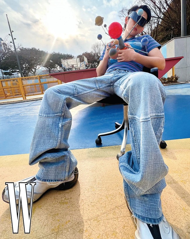 Pemotretan yang dilakukan di taman bermain itu juga memperlihatkan sisi kekanak-kanakan Im Siwan. Dia mengenakan striped polo shirt, denim pants, kacamata dengan bentuk yang tidak biasa, sambil memegang alat peraga tata surya. Foto: dok. W Korea