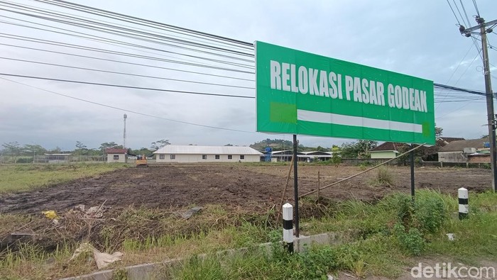 Papan petunjuk Relokasi Pasar Godean terpasang di sisi selatan pasar yang berhadapan langsung dengan Jalan Godean, Sidoluhur, Godean, Sleman, Kamis (23/1/2025).