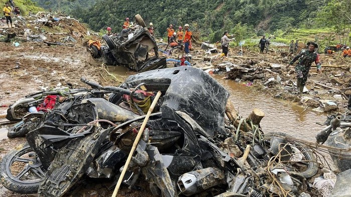 The wreckage of a car is stuck in the mud at an area affected by a landslide following a flash flood in Pekalongan, Central Java, Indonesia, Wednesday, Jan. 22, 2025. (AP Photo/Janaki DM)