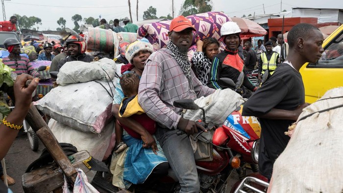 Civilians carry their belongings as they flee from the Nzulo camp for the internally displaced to Goma, as fighting intensifies between the M23 rebels and the Armed Forces of the Democratic Republic of the Congo (FARDC), near Goma, Democratic Republic of Congo January 22, 2025. REUTERS/Arlette Bashizi