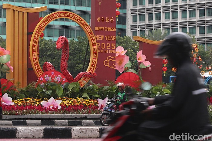 Sejumlah pengendara melintasi dekorasi Tahun Baru Imlek di Bundaran HI, Jakarta, Selasa (28/1/2025).