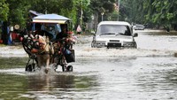 Pengendara nekat menerobos banjir yang merendam Jalan Boulevard Barat Raya, Kelapa Gading, Jakarta Utara.