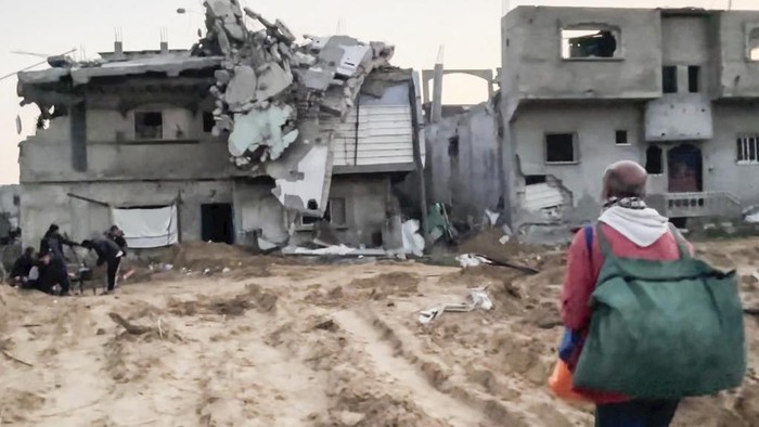 In this image made from an Associated Press video, Neman Abu Jarad and his family return to their home in Beit Lahiya, Gaza Strip, on Monday, Jan. 29, 2025, for the first time since the war between Hamas and Israel began. (AP Photo)