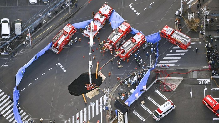 An aerial view shows rescue operations underway at a large sinkhole that swallowed a truck at an intersection in Yashio, north of Tokyo, Japan January 28, 2025, in this photo taken by Kyodo. Mandatory credit Kyodo/via REUTERS ATTENTION EDITORS - THIS IMAGE HAS BEEN SUPPLIED BY A THIRD PARTY. MANDATORY CREDIT. JAPAN OUT. NO COMMERCIAL OR EDITORIAL SALES IN JAPAN.     TPX IMAGES OF THE DAY