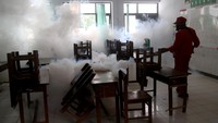 Petugas dari Dinas Kesehatan melakukan pengasapan (fogging) di ruang kelas SD Negeri Tempurejo 1, Kota Kediri, Jawa Timur, Kamis (30/1/2025). 