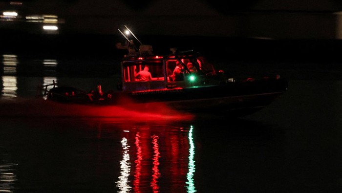 A search and rescue boat operates along the Potomac River near the site of the crash after American Eagle flight 5342 collided with a helicopter while approaching Ronald Reagan Washington National Airport and crashed in the Potomac River, outside Washington, U.S., January 29, 2025. REUTERS/Carlos Barria TPX IMAGES OF THE DAY