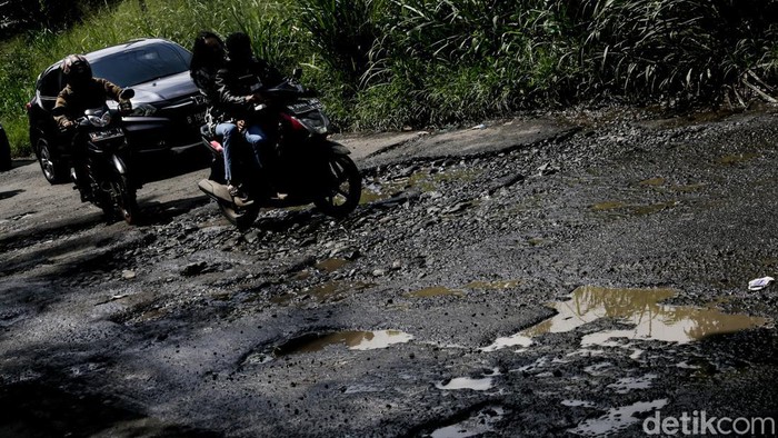 Awas! Jalan Gunung Sindur Arah Serpong Rusak Pengendara melintas di Jalan Raya Serpong-Gunung Sindur, Bogor, Jumat (31/1/2025). Kondisi jalanan rusak dan berlubang.