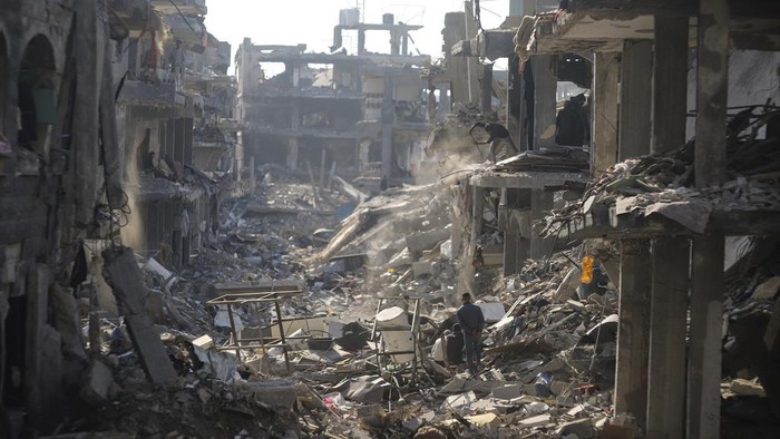 Palestinians inspect their homes destroyed by Israeli attacks in Jebaliya, northern Gaza Strip, Wednesday, Jan. 29, 2025. (AP Photo/Jehad Alshrafi)