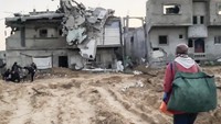 Meski bangunan rumah telah hancur, hal itu tak mengurangi kebahagian mereka. (AP Photo)