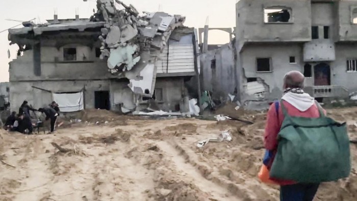 In this image made from an Associated Press video, Neman Abu Jarad and his family return to their home in Beit Lahiya, Gaza Strip, on Monday, Jan. 29, 2025, for the first time since the war between Hamas and Israel began. (AP Photo)