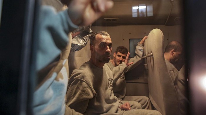 Freed Palestinian prisoners wave from a bus as they arrive in the Gaza Strip after being released from an Israeli prison following a ceasefire agreement between Hamas and Israel in Khan Younis, Thursday, Jan. 30, 2025. (AP Photo/Jehad Alshrafi)