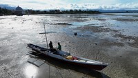 Foto udara nelayan berada di samping perahunya di laut Pantai Mandra yang mengalami pendangkalan di Kolaka, Sulawesi Tenggara, Jumat (31/1/2025).  