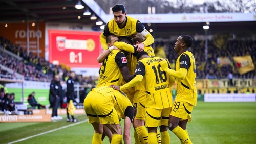 Dortmunds Serhou Guirassy, covered, celebrates with teammates after scoring the opening goal during the German Bundesliga soccer match between Heidenheim and Borussia Dortmund at the Voith-Arena in Heidenheim, Germany, Saturday, Feb. 1, 2025 (Tom Weller/dpa via AP)