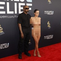 Saat berjalan ke karpet merah, awalnya Bianca bersama Kanye tampil normal mengenakan baju serba hitam. Namun setelah mendapatkan atensi dari para fotografer, tiba-tiba Bianca membalikan badan dan membuka jubahnya. Di baliknya, ia hanya baju transparan yang menutupi bagian intimnya.Foto: Frazer Harrison / GETTY IMAGES NORTH AMERICA / Getty Images via AFP