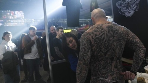A man with a tattoo on his chest takes part in a contest during a tattoo convention, in Paris, Sunday, Feb. 2, 2025. (AP Photo/Thibault Camus)