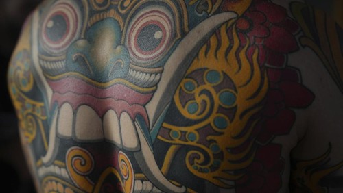 A man with a tattoo on his chest takes part in a contest during a tattoo convention, in Paris, Sunday, Feb. 2, 2025. (AP Photo/Thibault Camus)