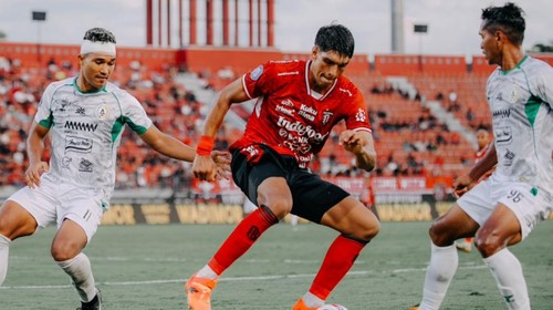 Center back Bali United, Elias Dolah (jersei merah) dikepung dua pemain PSS Sleman di pertemuan pertama dalam Liga 1 2024/2025 di Stadion Kapten I Wayan Dipta, Senin (16/9/2024).