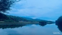 Pemandangan di sekitar pantai dengan gunung di kejauhan